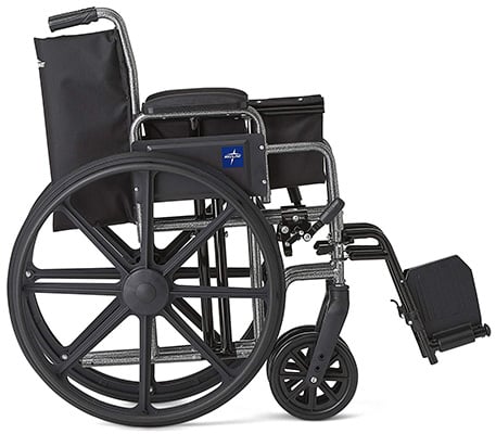 Folded Medline K1 Basic Extra-Wide Wheelchair in a standing position