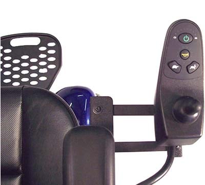 A joystick controller attached to the right armrest of a wheelchair
