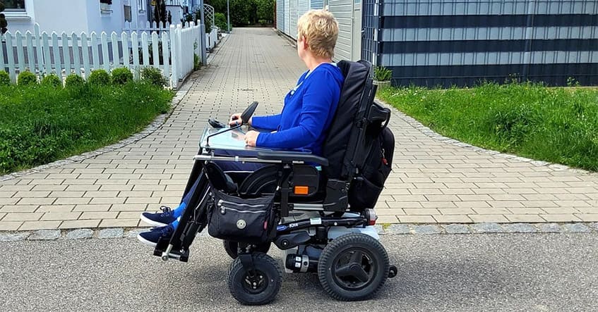 A female on a motorized wheelchair outdoor