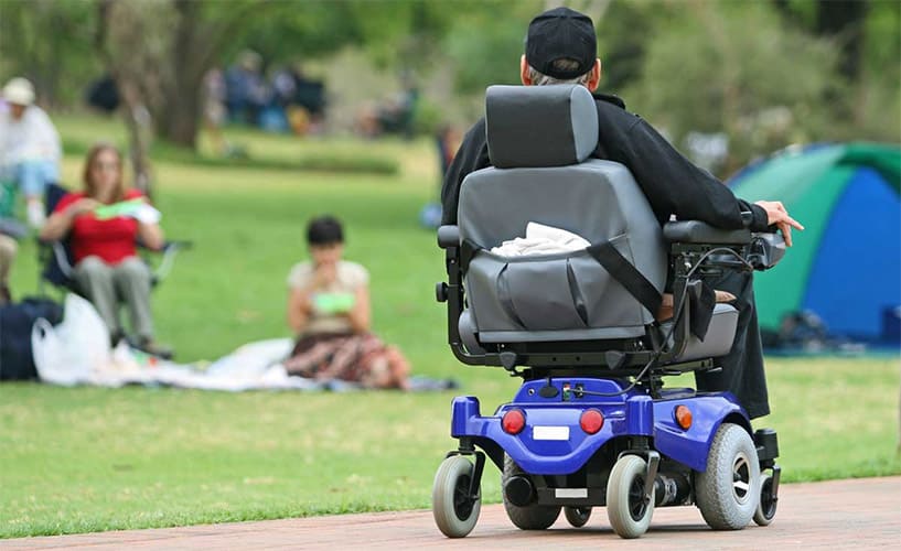 A man on his powerchair with power speed selection in a public place