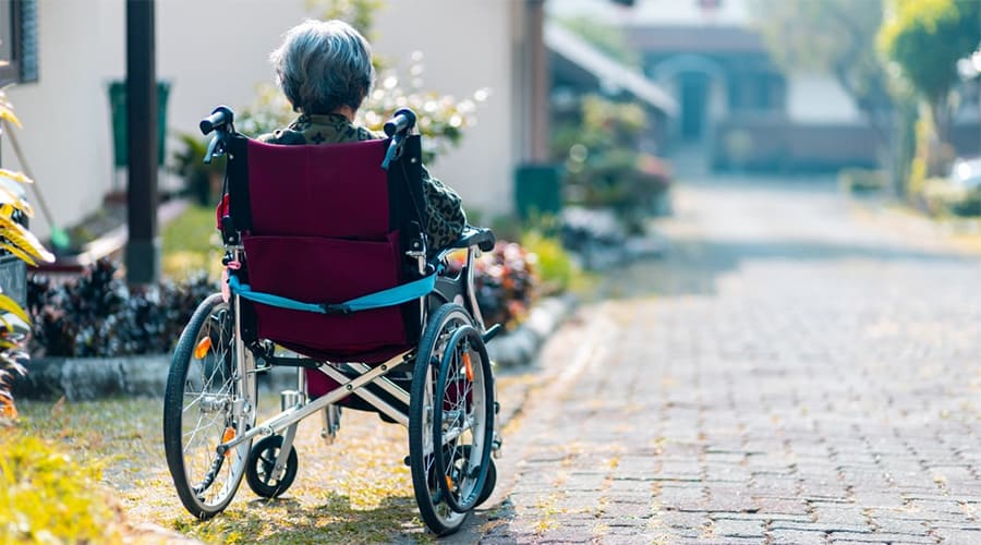 An old woman in a wheelchair outdoor