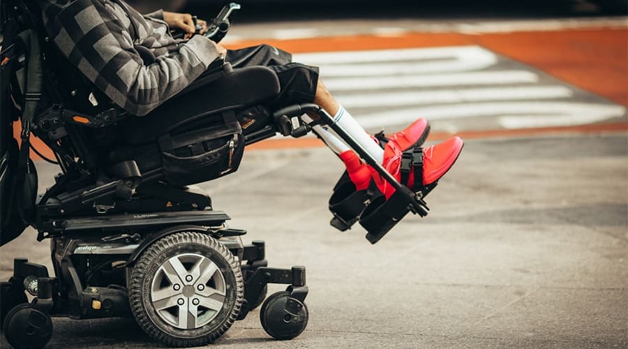 A person in a power wheelchair in an inclined position
