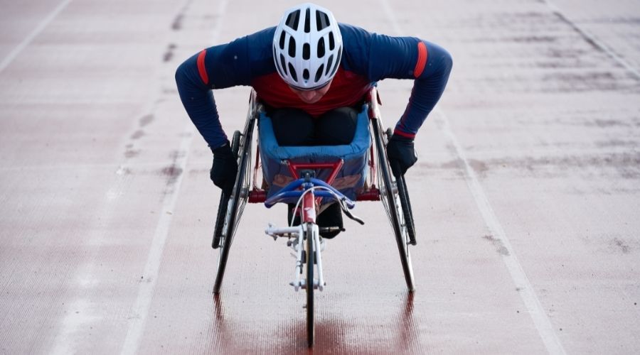 A man in a racing wheelchair on a racing track 