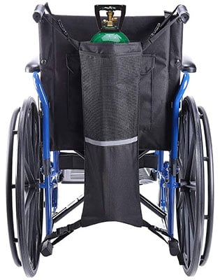 An Oxygen tank inside a cylinder bag attached to the back of a wheelchair