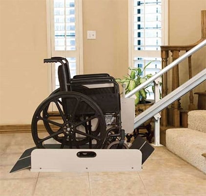 A wheelchair on a stairlift for home