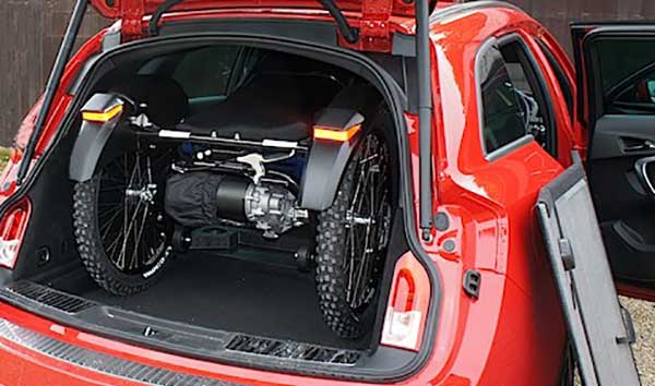 Folded Boma 7 All Terrain Wheelchair  inside the trunk of a hatchback car