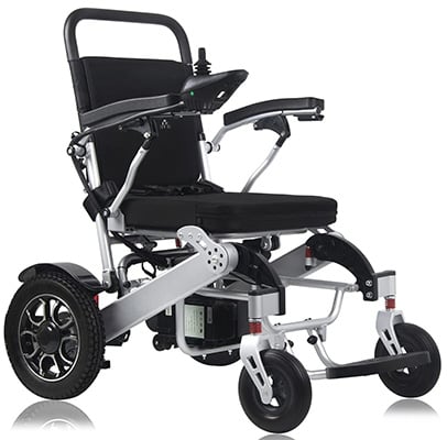An electric wheelchair with a padded seat and joystick controller attached to the right armrest