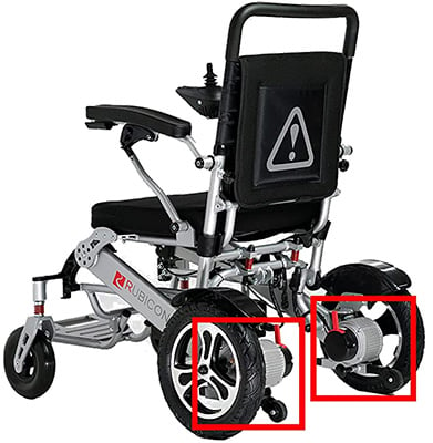 Free-wheel release levers attached to the rear wheels of an all-terrain power wheelchair