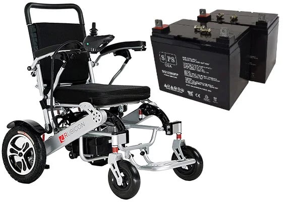 A power wheelchair right next to two wheelchair batteries 