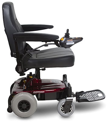 Shoprider Jimmie Power Wheelchair with a padded seat, armrests, and a joystick attached to the right armrest